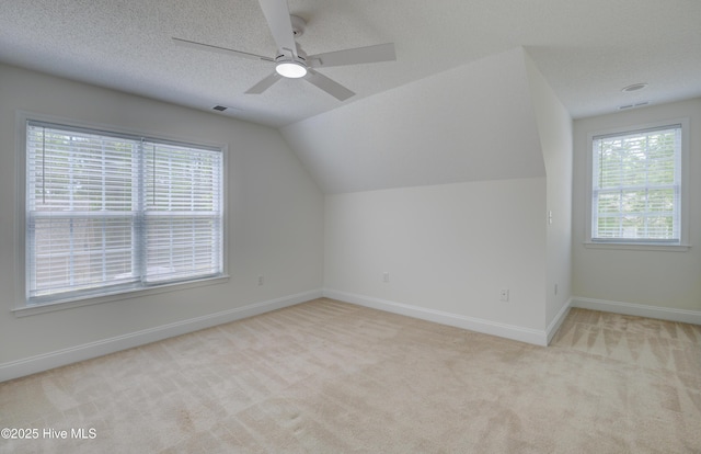 1708 N County Dr, Castle Hayne, NC 28429 - additional living space featuring carpet floors, ceiling fan, baseboards, lofted ceiling, and a textured ceiling
