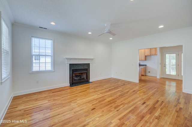 1708 N County Dr, Castle Hayne, NC 28429 - unfurnished living room featuring light wood-type flooring, healthy amount of natural light, a ceiling fan, ornamental molding, and recessed lighting