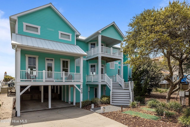 449 Maritime Pl, Pine Knoll Shores, NC 28512 - coastal inspired home with a porch, a carport, a balcony, and stairway