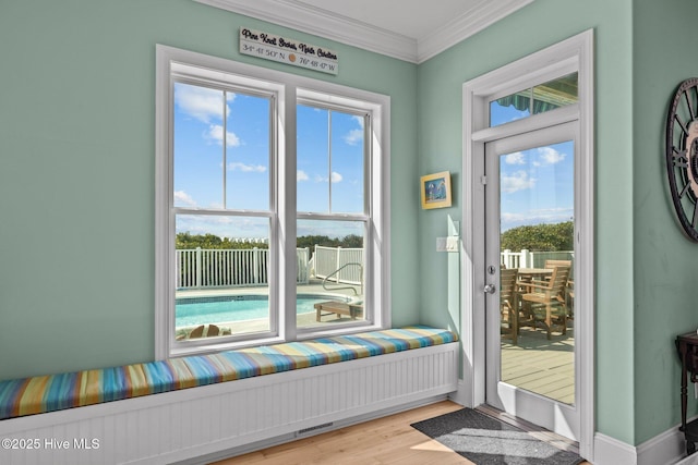 449 Maritime Pl, Pine Knoll Shores, NC 28512 - doorway with ornamental molding, healthy amount of natural light, and wood finished floors
