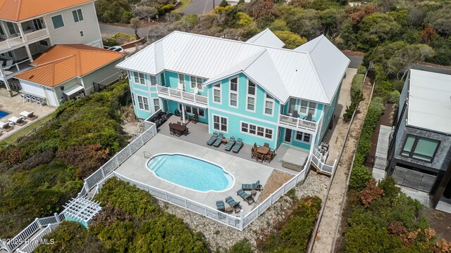 449 Maritime Pl, Pine Knoll Shores, NC 28512 - rear view of house featuring a balcony, a fenced backyard, outdoor dining area, a patio area, and metal roof
