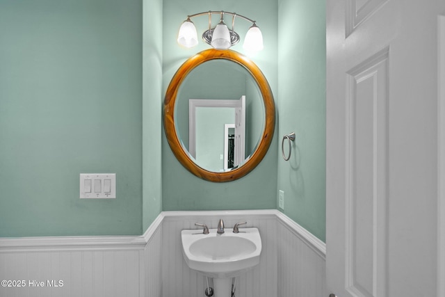 449 Maritime Pl, Pine Knoll Shores, NC 28512 - bathroom featuring wainscoting and a sink