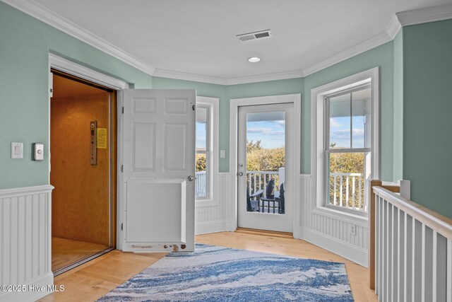 449 Maritime Pl, Pine Knoll Shores, NC 28512 - entrance foyer with wainscoting, crown molding, light wood-style flooring, and recessed lighting