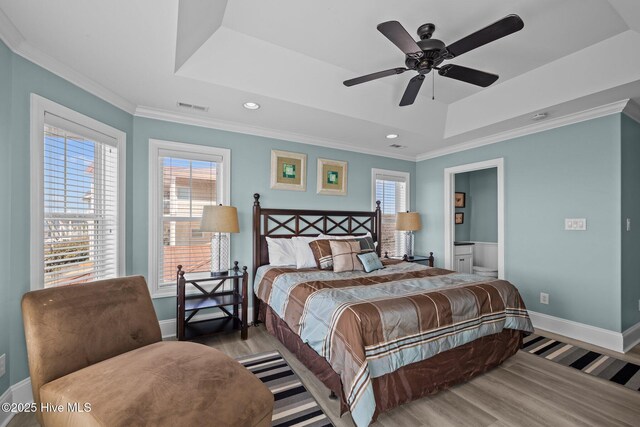 449 Maritime Pl, Pine Knoll Shores, NC 28512 - bedroom featuring a raised ceiling, wood finished floors, multiple windows, baseboards, and ornamental molding