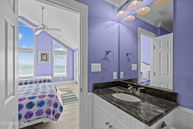 449 Maritime Pl, Pine Knoll Shores, NC 28512 - ensuite bathroom featuring a ceiling fan, vanity, lofted ceiling, wood finished floors, and ornamental molding