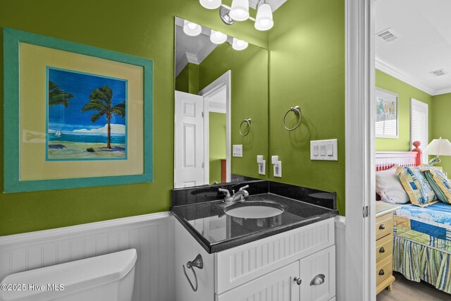 449 Maritime Pl, Pine Knoll Shores, NC 28512 - half bath featuring crown molding, toilet, vanity, a wainscoted wall, and a chandelier