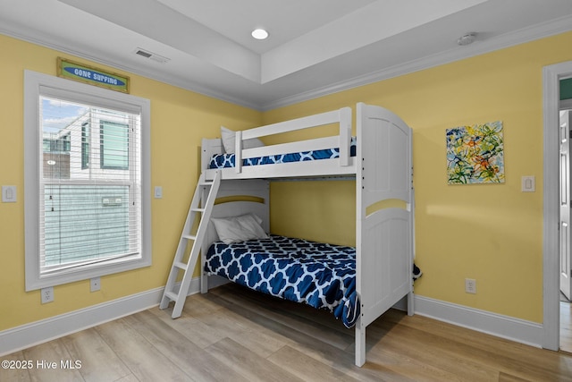 449 Maritime Pl, Pine Knoll Shores, NC 28512 - bedroom with baseboards, wood finished floors, ornamental molding, and a tray ceiling