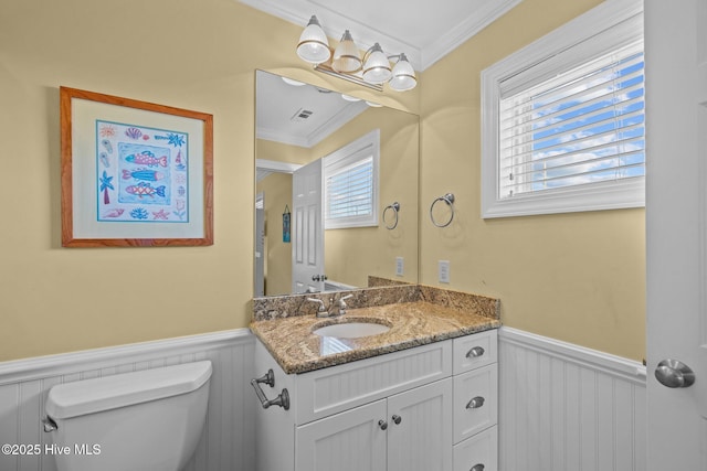 449 Maritime Pl, Pine Knoll Shores, NC 28512 - bathroom featuring a wainscoted wall, crown molding, toilet, vanity, and a decorative wall
