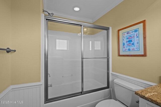 449 Maritime Pl, Pine Knoll Shores, NC 28512 - bathroom featuring a wainscoted wall, vanity, ornamental molding, shower / bath combination with glass door, and toilet