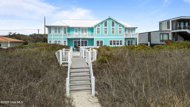 449 Maritime Pl, Pine Knoll Shores, NC 28512 - view of front of home with metal roof and a standing seam roof