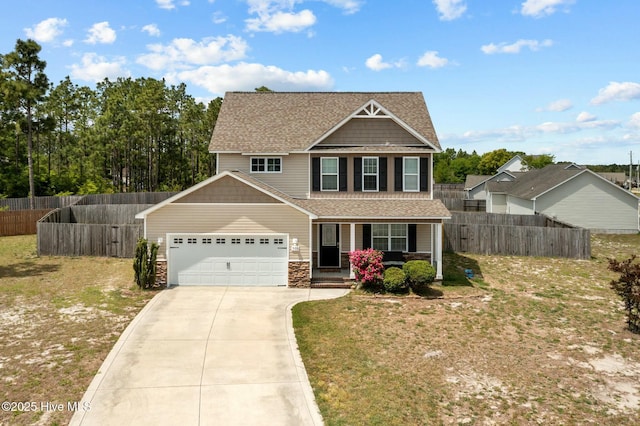 craftsman inspired home with covered porch, fence, an attached garage, and driveway