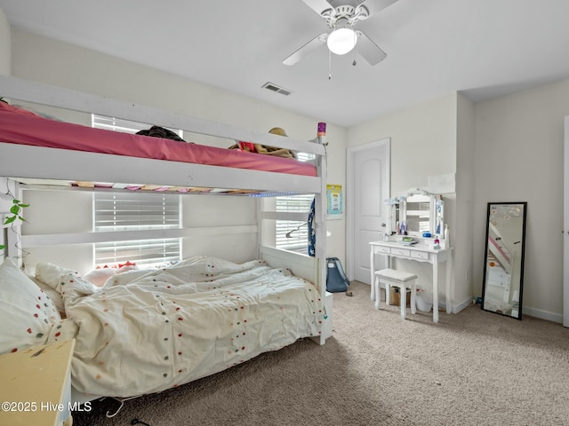 bedroom featuring a ceiling fan, visible vents, and carpet