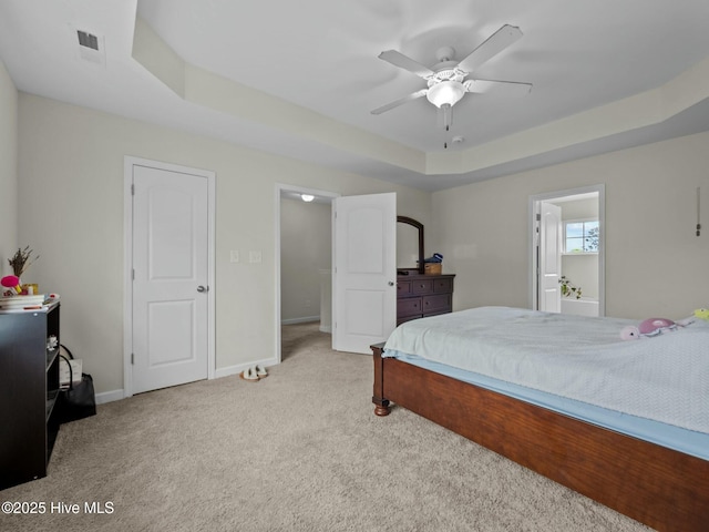 bedroom featuring a ceiling fan, visible vents, carpet floors, baseboards, and a raised ceiling