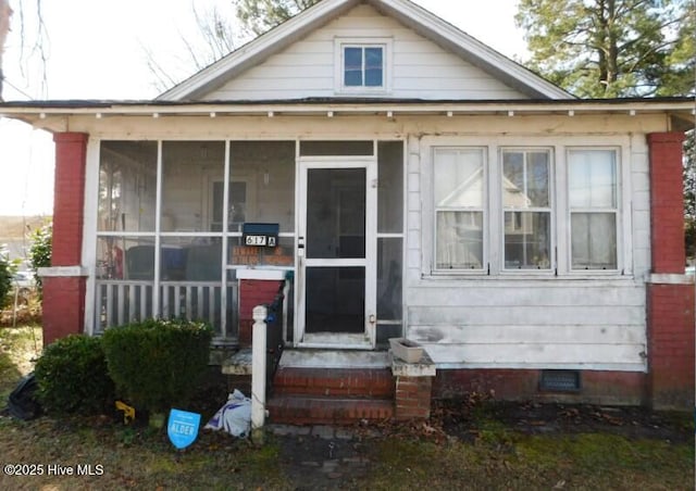 bungalow-style house featuring crawl space and a sunroom