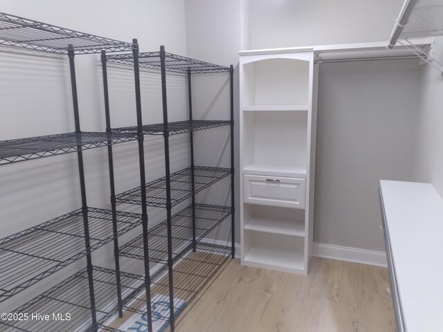 spacious closet with wood finished floors
