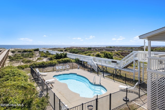 601 Caswell Beach Rd, Caswell Beach, NC 28465 - community pool with fence, a patio area, stairway, and a water view