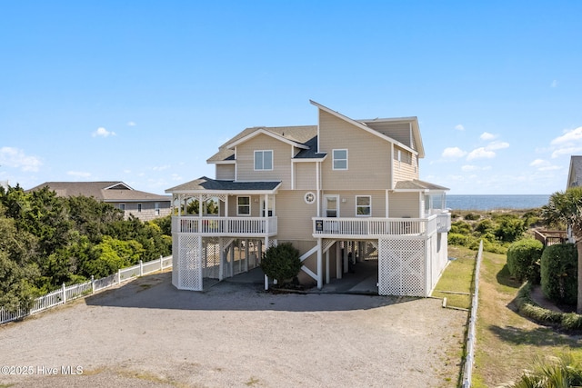601 Caswell Beach Rd, Caswell Beach, NC 28465 - back of property with fence, a carport, and dirt driveway