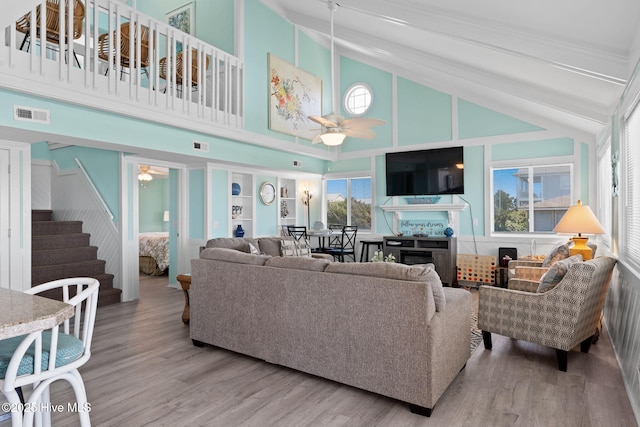 601 Caswell Beach Rd, Caswell Beach, NC 28465 - living area with visible vents, wood finished floors, stairs, and ceiling fan