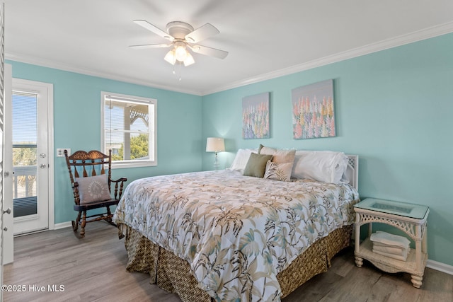 601 Caswell Beach Rd, Caswell Beach, NC 28465 - bedroom featuring crown molding, baseboards, access to outside, and wood finished floors