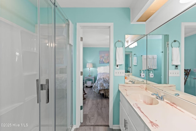 601 Caswell Beach Rd, Caswell Beach, NC 28465 - ensuite bathroom featuring ensuite bathroom, wood finished floors, vanity, and a stall shower