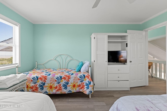 601 Caswell Beach Rd, Caswell Beach, NC 28465 - bedroom featuring ceiling fan, crown molding, and wood finished floors
