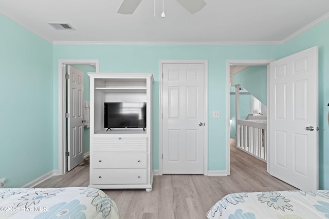 601 Caswell Beach Rd, Caswell Beach, NC 28465 - bedroom featuring wood finished floors, visible vents, baseboards, and ornamental molding