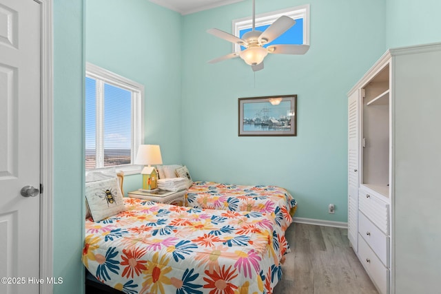 601 Caswell Beach Rd, Caswell Beach, NC 28465 - bedroom featuring a high ceiling, baseboards, a ceiling fan, and light wood finished floors