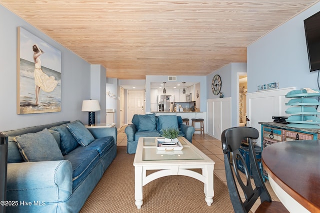 carpeted living area with wooden ceiling and visible vents