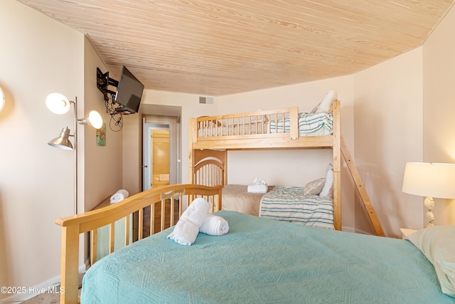 bedroom with baseboards, visible vents, and wooden ceiling