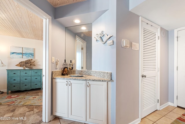 bathroom with tile patterned floors, vanity, baseboards, and recessed lighting