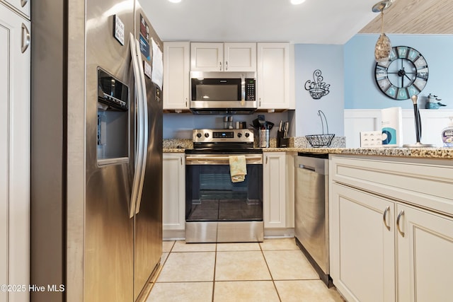kitchen featuring stainless steel appliances, light stone counters, recessed lighting, light tile patterned floors, and white cabinets