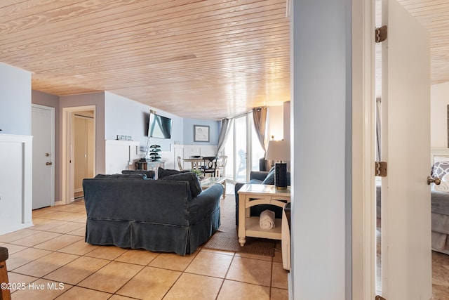 living room with wood ceiling and light tile patterned floors