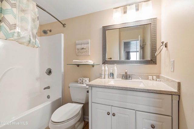 full bath featuring toilet, vanity, and washtub / shower combination