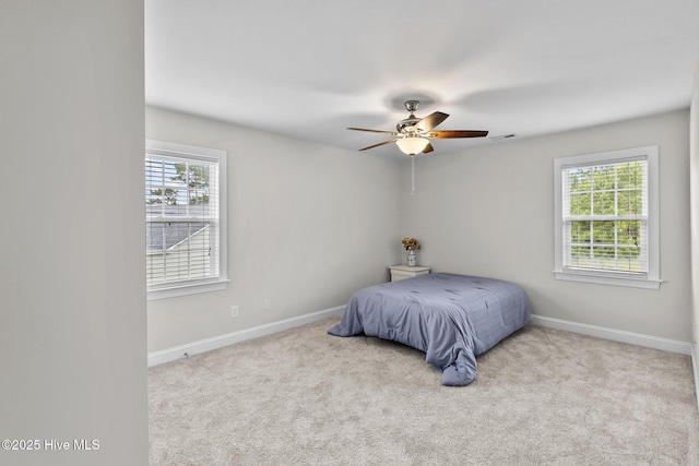705 Shearwater Ln, Swansboro, NC 28584 - bedroom featuring multiple windows, baseboards, carpet, and ceiling fan