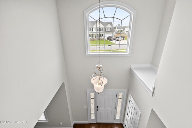 705 Shearwater Ln, Swansboro, NC 28584 - entrance foyer with a chandelier, dark wood finished floors, and a high ceiling
