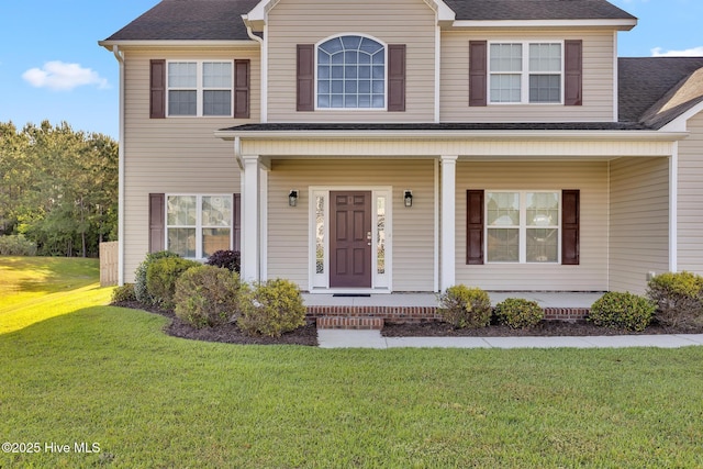 705 Shearwater Ln, Swansboro, NC 28584 - view of front of home with a porch, a front lawn, and roof with shingles