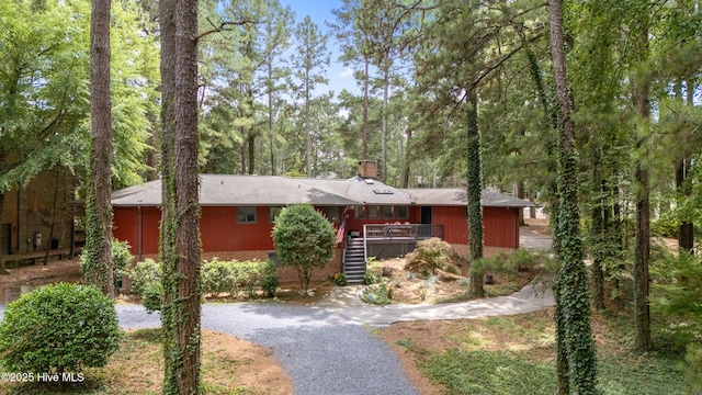 40 Inverness Rd, Pinehurst, NC 28374 - view of front facade featuring stairway, driveway, a chimney, and a deck