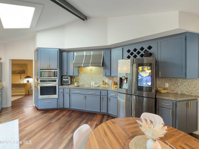 40 Inverness Rd, Pinehurst, NC 28374 - kitchen with stainless steel appliances, extractor fan, blue cabinetry, a skylight, and backsplash