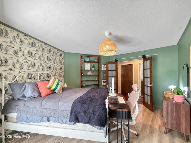 40 Inverness Rd, Pinehurst, NC 28374 - bedroom featuring wood finished floors, a textured ceiling, and french doors