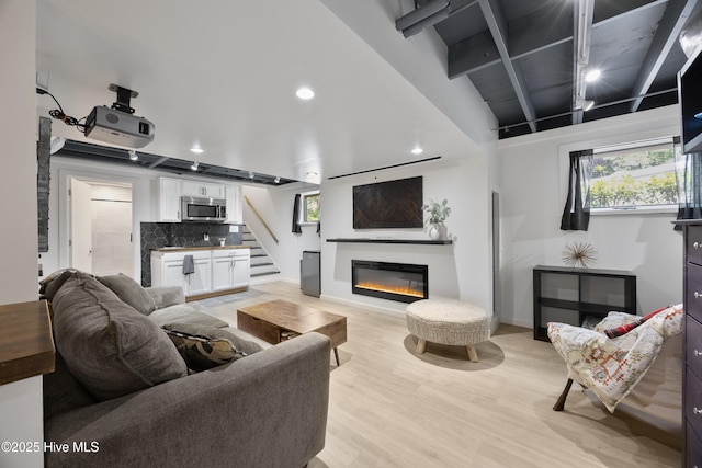 40 Inverness Rd, Pinehurst, NC 28374 - living area featuring light wood finished floors, stairway, a glass covered fireplace, and recessed lighting
