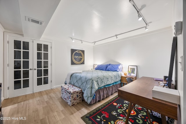 40 Inverness Rd, Pinehurst, NC 28374 - bedroom with rail lighting, french doors, and wood finished floors