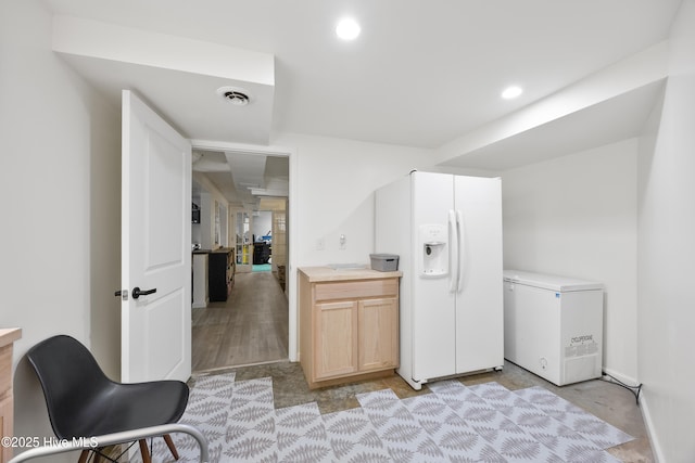 40 Inverness Rd, Pinehurst, NC 28374 - kitchen featuring refrigerator, white fridge with ice dispenser, light countertops, recessed lighting, and light brown cabinets