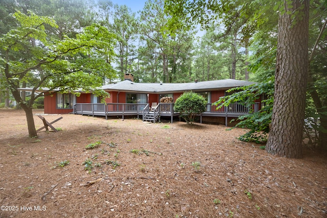 40 Inverness Rd, Pinehurst, NC 28374 - rear view of house featuring a wooden deck and a chimney