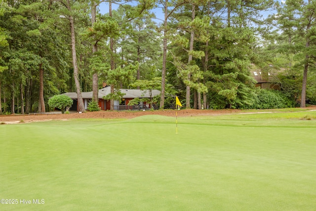 40 Inverness Rd, Pinehurst, NC 28374 - surrounding community with a putting area, view of golf course, and view of wooded area