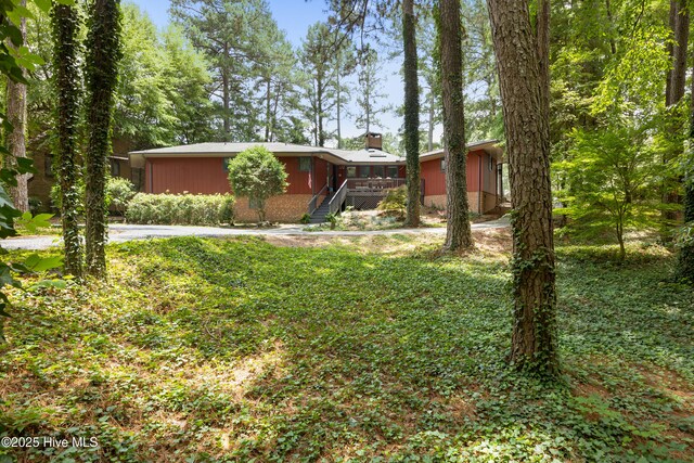 40 Inverness Rd, Pinehurst, NC 28374 - view of front of home with a chimney, a wooden deck, and stairway