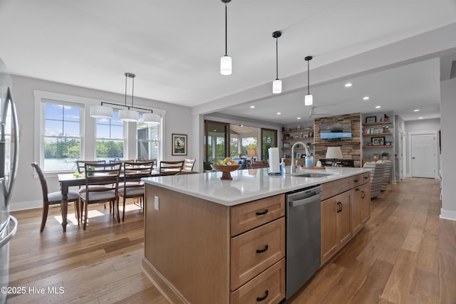 122 Back Creek Dr, Hertford, NC 27944 - kitchen featuring stainless steel dishwasher, a stone fireplace, light wood-type flooring, light countertops, and a sink