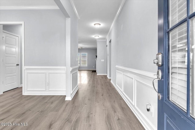 144 Violetear Rdg, Hampstead, NC 28443 - hall with crown molding, light wood-type flooring, wainscoting, and a decorative wall