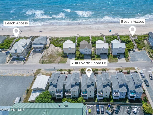 bird's eye view featuring a water view, a beach view, and a residential view
