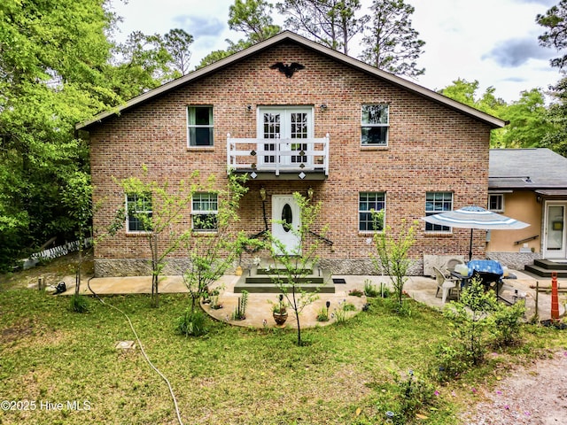 14 Sunnyvale Dr, Wilmington, NC 28412 - back of house featuring a lawn, brick siding, and a patio
