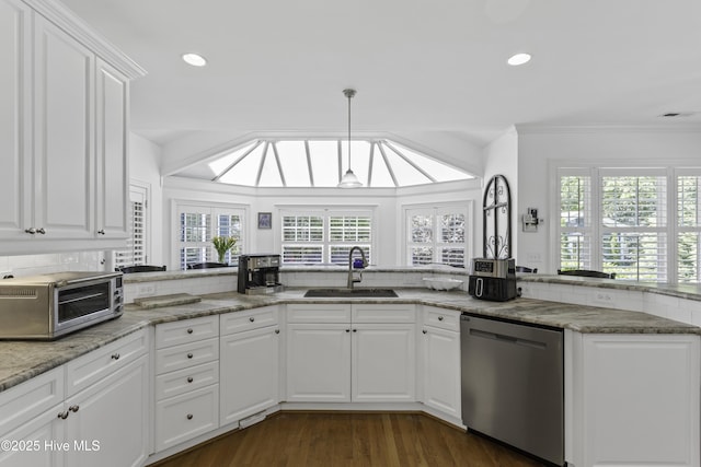 kitchen with stainless steel dishwasher, a sink, a toaster, white cabinetry, and visible vents